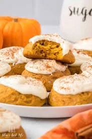 Delicious pumpkin cookies with cream cheese frosting on a white plate